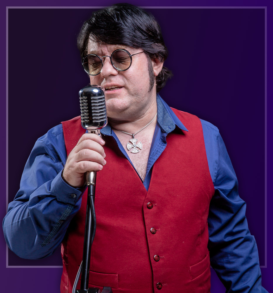 Dave Collison singing into a vintage microphone, in a red waistcoat